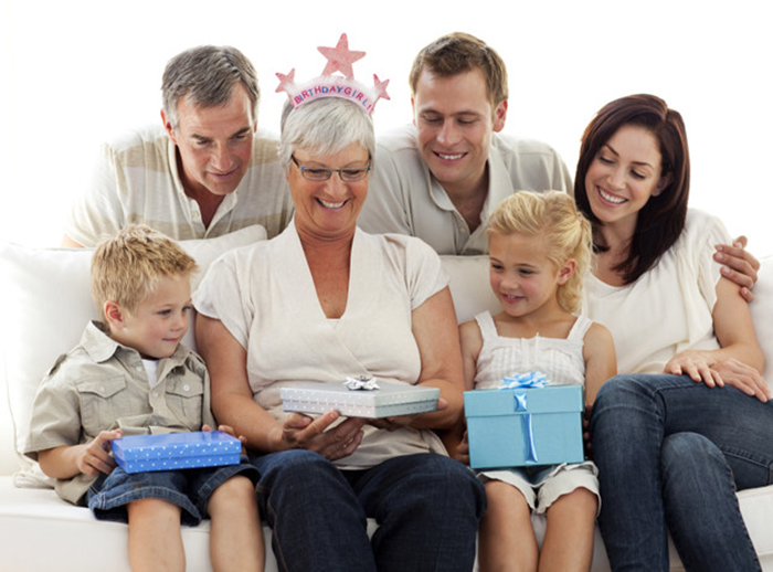 Family giving a gift to grandmother for her birthday